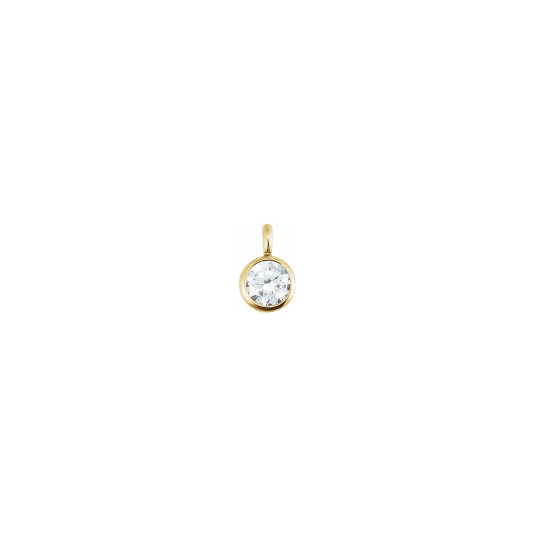 Petite 14k yellow gold diamond bezel charm on a white background