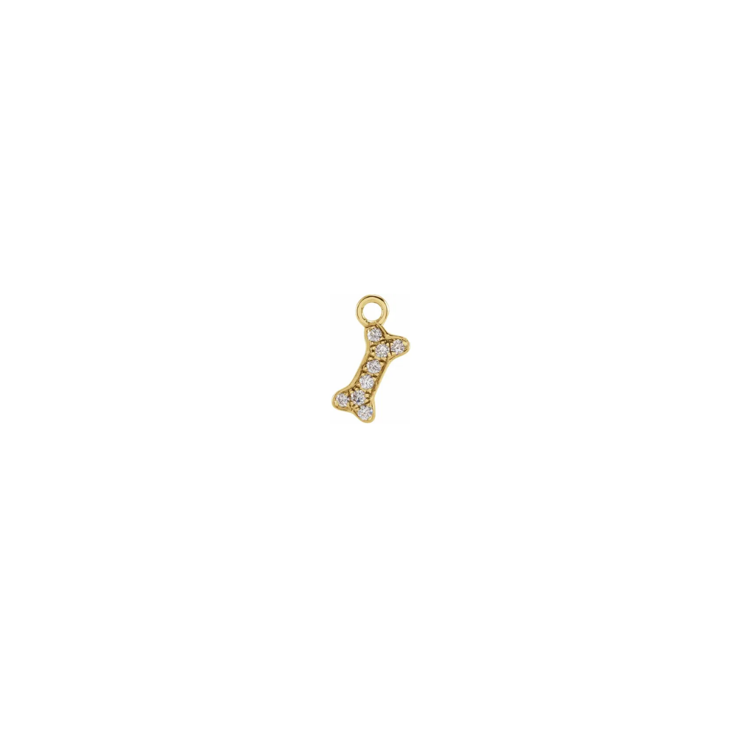 Petite 14k yellow gold diamond dog bone charm on a white background