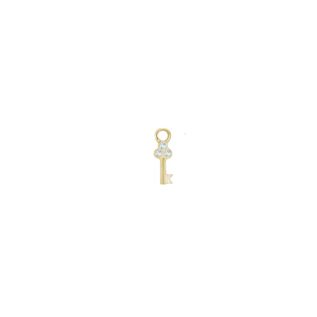 Petite 14k yellow gold diamond key charm on a white background