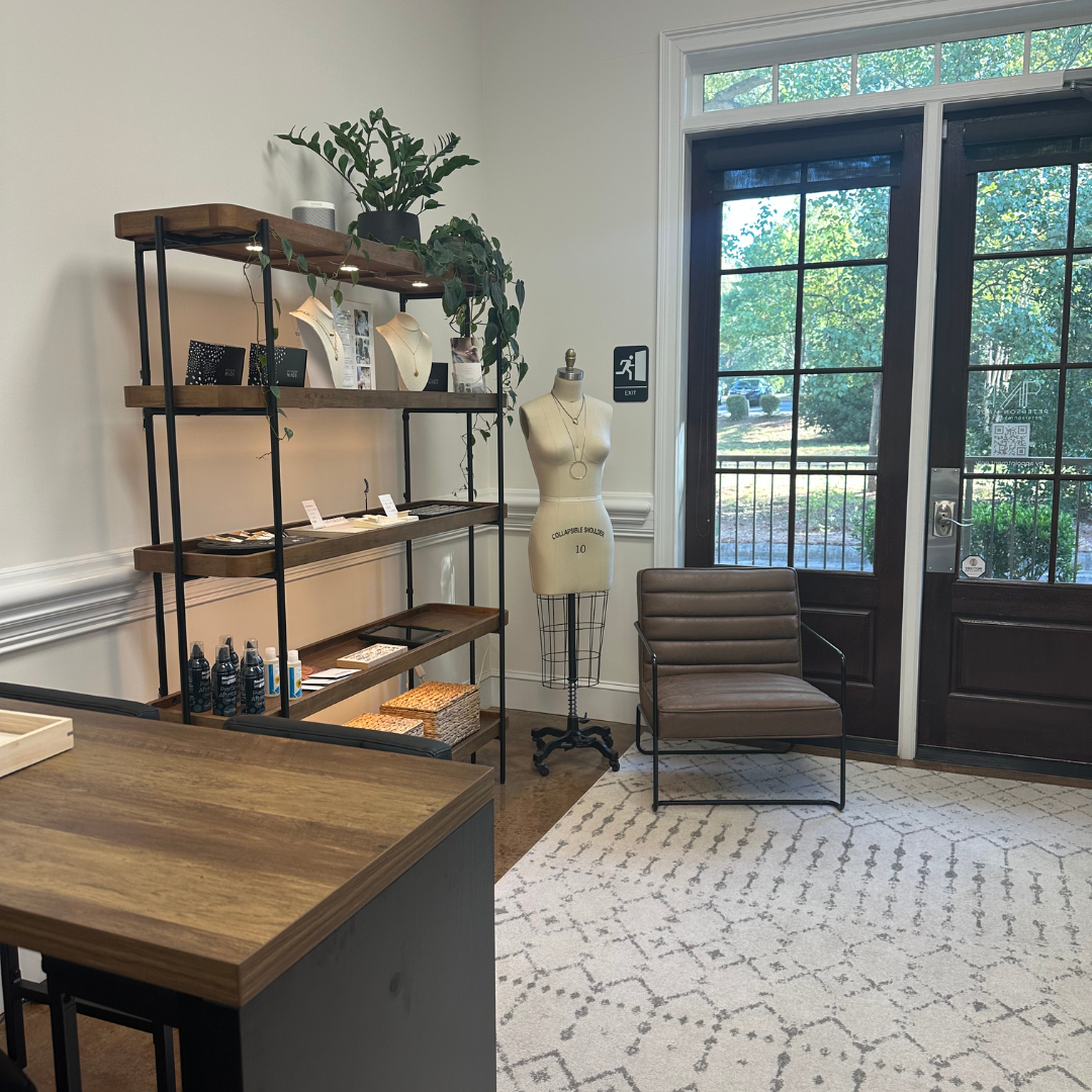 Inside the Peterson MADE studio on W. Charles St in Matthews, NC, with fine jewelry displays and a welcoming seating and consult area.