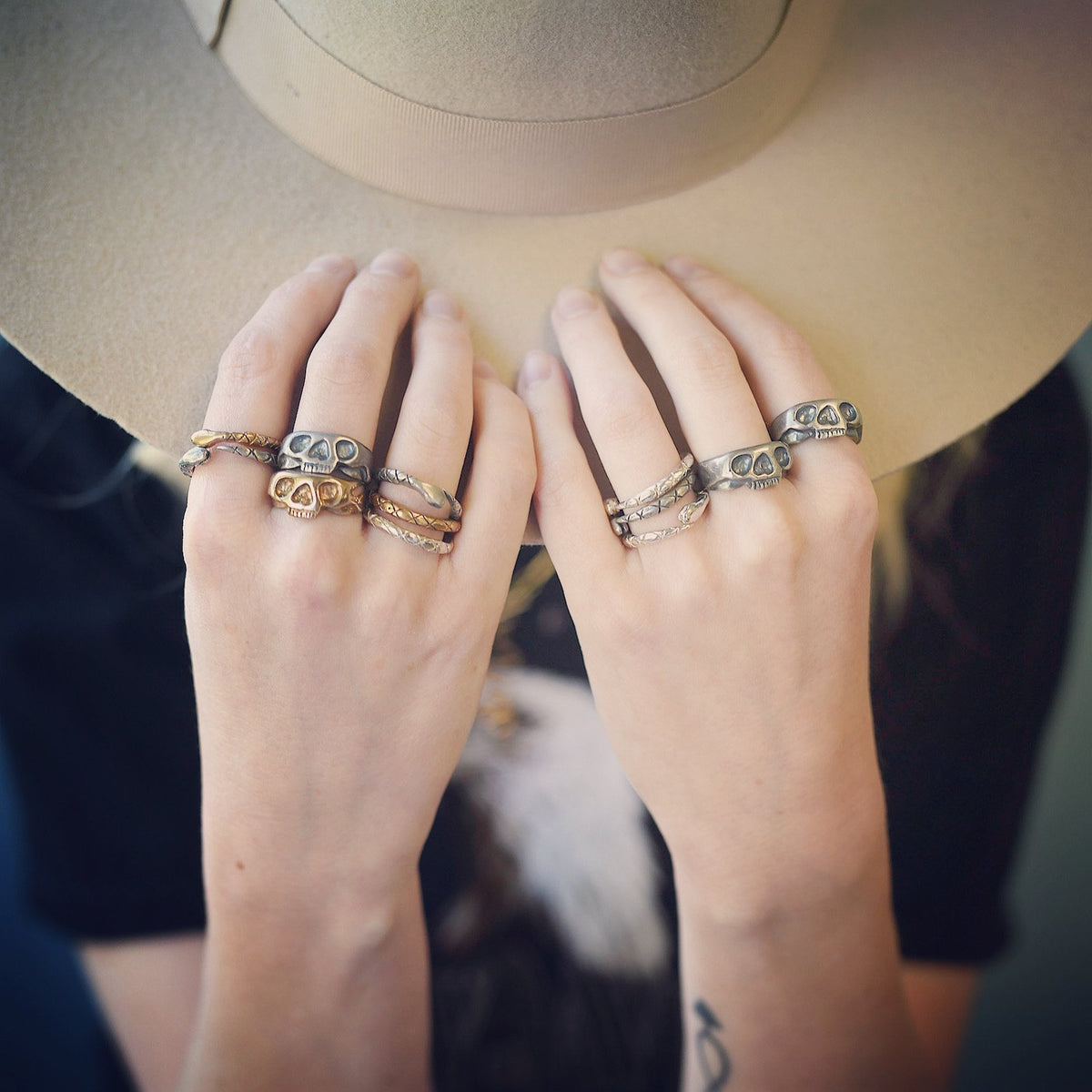 Snake Stacking Rings shown in sterling Silver and bronze mixed metals. Shown worn on fingers next to The First Born Skull Ring. 