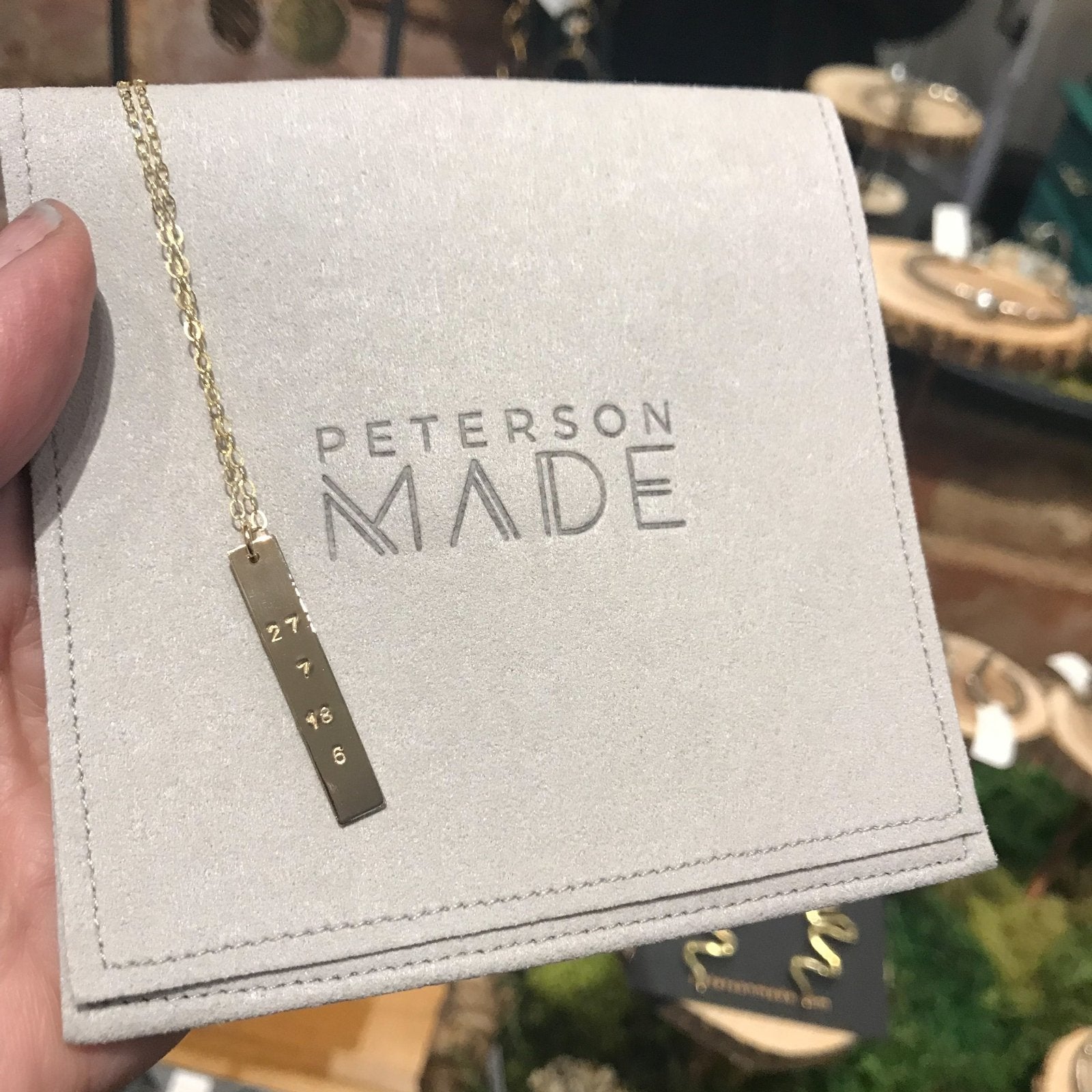 Bar Charm shown in a vertical placement on a necklace.  